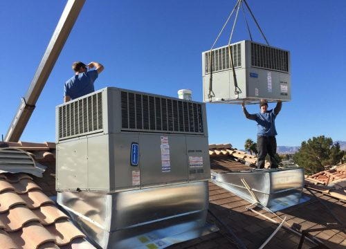 HVAC technicians installing rooftop air conditioning equipment